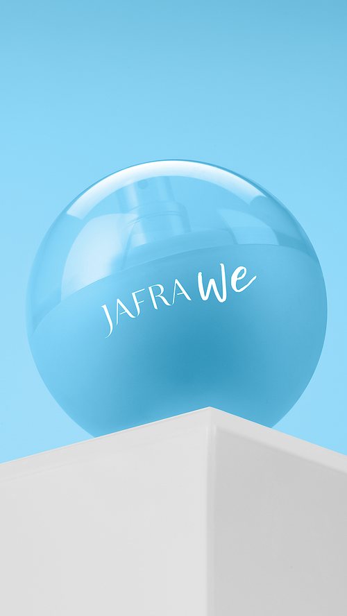 Jafra We bottle on a white pedestal against blue